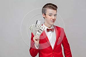 Portrait of handsome man showing bunch of dollars and bank card. studio shot isolated on white