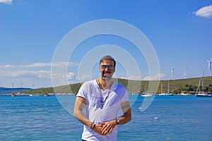 Portrait of handsome man in sunglasses smiling at camera