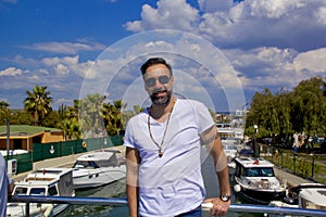 Portrait of handsome man in sunglasses smiling at camera