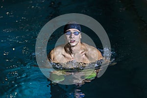 Portrait of a handsome man swimming