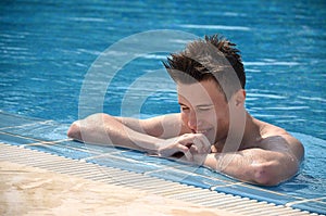 Portrait of handsome man in swimming pool