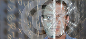 Portrait of handsome man with tech pattern on eye and wireframe on the half of a face. Digital ID concept, eye recognition,