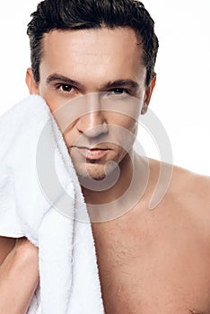 Portrait of handsome man toweling after shower in morning isolated.