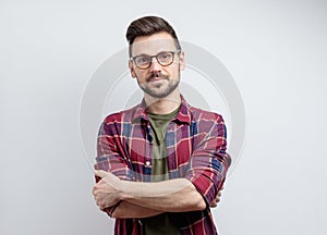 Portrait of a handsome man wearing glasses on grey background