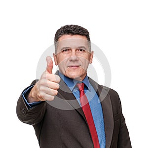 Portrait handsome man wearing suit and blue shirt showing thumb up