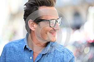 Portrait of handsome man wearing trendy eyeglasses