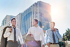 Portrait of handsome mature businessmen walking while talking after work