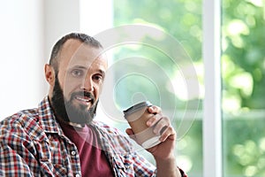 Portrait of handsome mature man with coffee