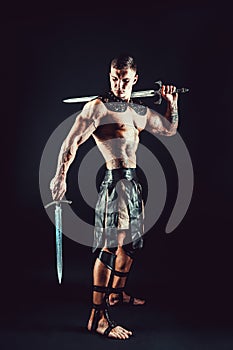 Severe barbarian in leather costume with sword