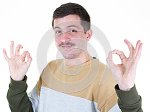 Portrait of handsome mustache  man smiling and showing ok fingers sign at camera isolated over white background