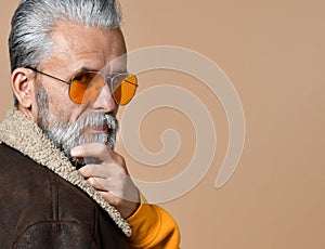 Portrait of handsome pensive senior man looking at camera