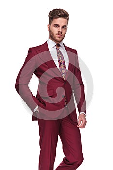 Portrait of handsome and relaxed young man in grena suit