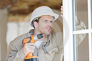 portrait handsome repairman with drill