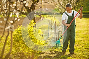 Portrait of a handsome senior man gardening in his garden