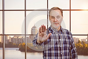 Portrait of a handsome serious confident man shows no gesture sign.