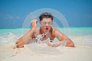 Portrait of handsome sexy muscled man at tropical beach island luxury resort