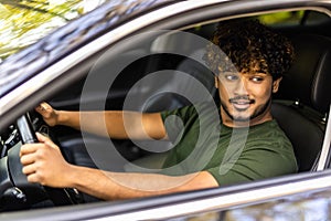 Portrait of an handsome smiling asian business man driving his car