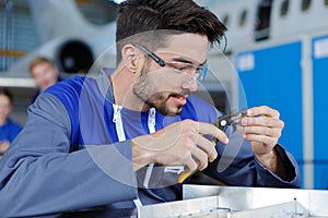 Portrait handsome smiling auto mechanic in blue overall