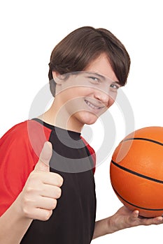 Portrait of a handsome smiling basketball player showing thumb u