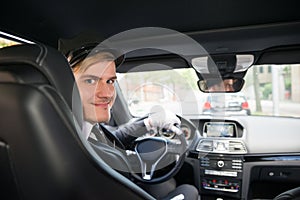 Portrait Of Smiling Young Chauffeur In Car