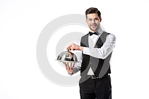 portrait of handsome smiling waiter in suit vest with serving tray