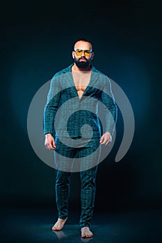 Portrait of handsome stylish man bodybuilder with naked torso in elegant suit