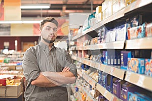 Portrait of handsome swedish man customer who is standing with note list in supermarket
