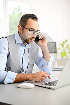 Portrait of handsome trendy casual mid age business man in office desk with laptop computer