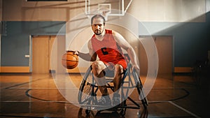 Portrait of Handsome Wheelchair Basketball Player Wearing Red Shirt Dribbling Ball, Looking at Cam