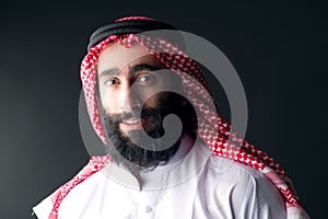 Portrait of a handsome young arabian man with a bushy beard