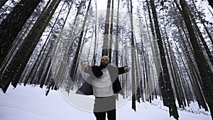 Portrait of handsome young bearded man in warm clothing standing outdoors in park on winter day. Media. Hipster blond