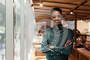 Portrait of handsome young black man in coffee shop