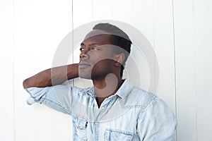 Portrait of a handsome young black man with hand in hair