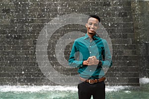 Portrait of handsome young black man outdoors in city