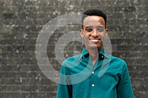 Portrait of handsome young black man outdoors in city