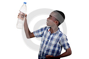 portrait of a handsome young boy contemplating a bottle of miner
