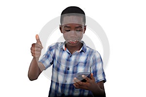portrait of handsome young boy looking at mobile phone and making okay gesture, smiling