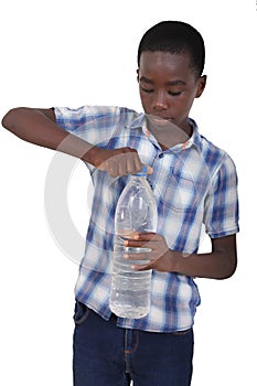 portrait of a handsome young boy opening a bottle of mineral water