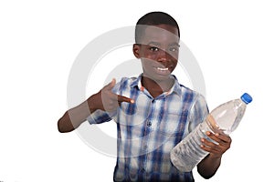 portrait of handsome young boy pointing bottle of mineral water, smiling