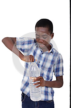 portrait of a handsome young boy trying to open a bottle of mineral water