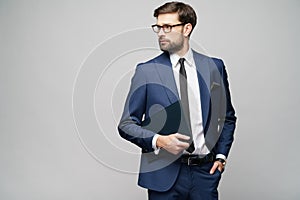 Portrait of a handsome young business man holding document folder