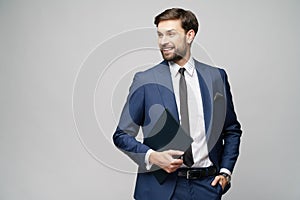 Portrait of a handsome young business man holding document folder