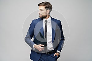 Portrait of a handsome young business man holding document folder