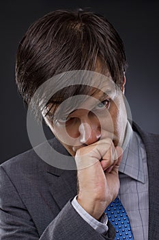 Portrait of handsome young business man thinking