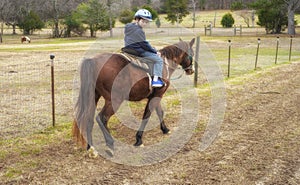 Portrait of handsome young caucasian male riding a horse