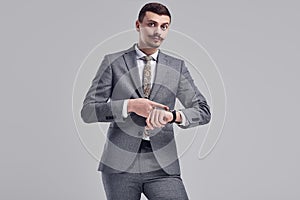 Handsome young arabic businessman with mustache in fashion gray suit