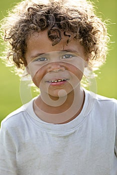 Portrait of a handsome young diverse black boy with curly hair