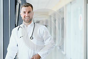 Portrait of handsome young doctor on hospital corridor