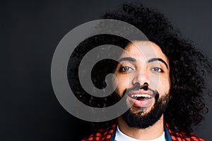 Portrait of a handsome young egyptian man with a beard looking at the camera
