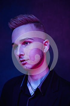 Portrait of handsome young guy against studio background.